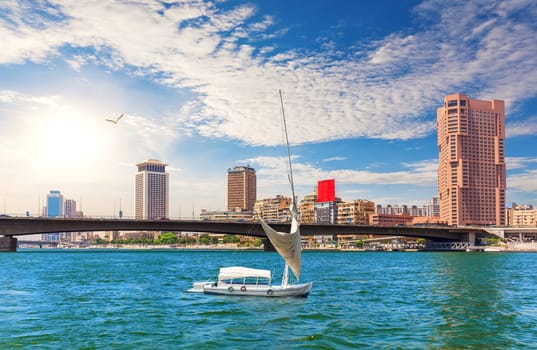 Bridge over the Nile, river board and fancy buildings of Cairo, beautiful day view, Egypt.