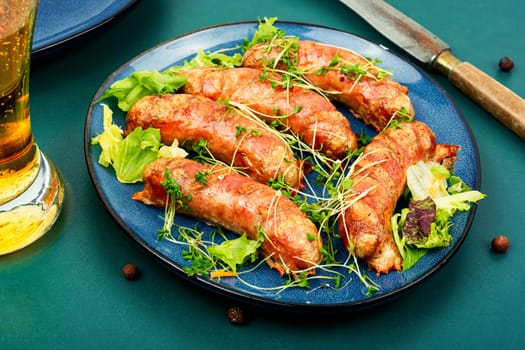 Fried sausage on plate, fast food. Barbecue bratwurst, Oktoberfest celebration.