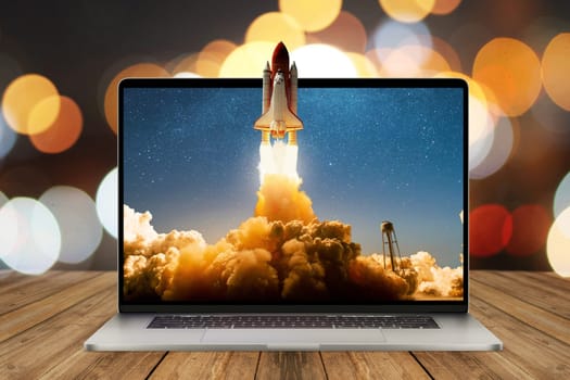 Space rocket shuttle with a cloud of smoke and blast lift off from a laptop on a working office desk with bokeh. Creative idea and startup. Successful business project. Rocket take off from display