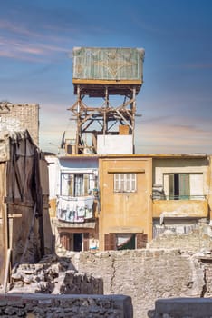 Wooden pigeon tower in a poor residential area in the middle of old, shabby buildings, one of the oldest methods of raising birds