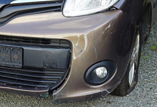 A broken car with paint damage and broken parts