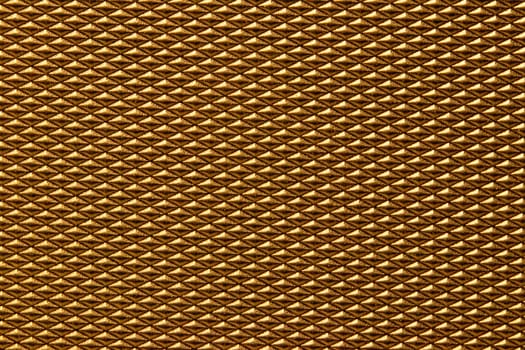 Seamless plastic texture background. Close-up of a detail from a gold glittering surface of a cosmetic bag. Beautiful backdrop. Macro.
