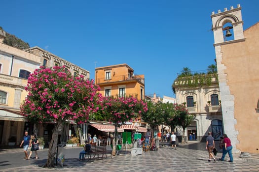 Sicily, Taormina, Italy - 28 September 2023. Tourists at Mainsquare Piazza IX Aprile and San Giuseppe church. City views, facades, architecture and the most popular streets.