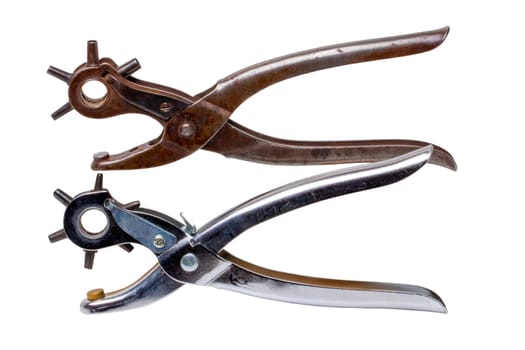Tailor accessories. Close-up of a antique adjustable steel punch pliers and a modern hole punch tool isolated. Clipping path. Tools from tailor, saddler or cobbler.