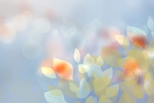 Abstract autumn gradient blue yellow pink bright green of fall colors background texture with leaves bokeh circles and sunlight. Indian summer. Card design with space for text. Beautiful backdrop.