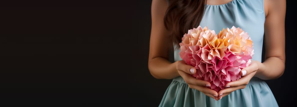 Holding a pink heart in the hand, volenteer and humanitarian help concept, charity and friendship, support and love