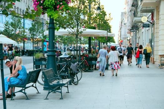 Central street of Lodz. People walking along city street. View of main street of Lodz. Central street of Lodz Piotrkowska. Cityscape. Urban panorama