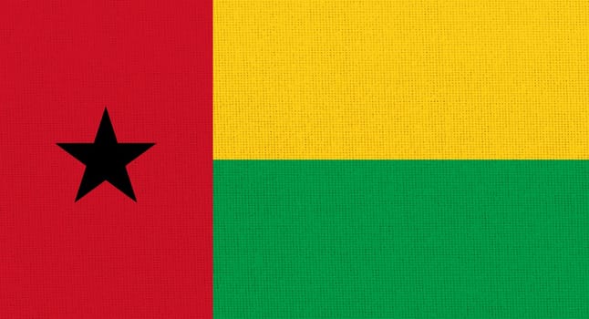 flag of Guinea-Bissau. National Guinea-Bissau flag on fabric surface. Guinea-Bissau national flag on textured background. Fabric Texture. African country