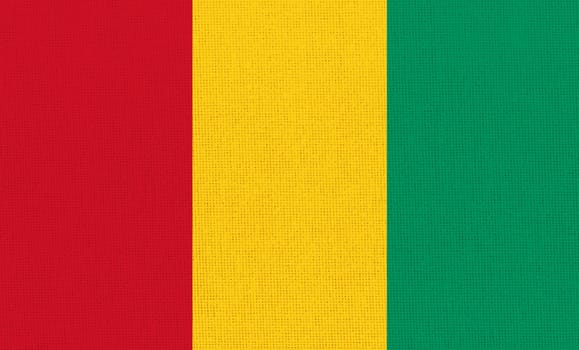 flag of Guinea. National Republic of Guinea flag on fabric surface. Guinea national flag on textured background. Fabric Texture. African country