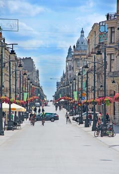Central street of Lodz. People walking along city street. View of main street of Lodz. Central street of Lodz Piotrkowska. Cityscape. Urban panorama