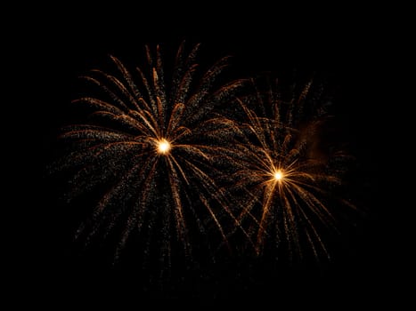 Festive golden fireworks display isolated on black background for celebration and anniversary