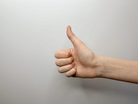 a hand gesture showing that everything is fine on a light background