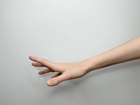 on a light background, a gentle female hand, palm down