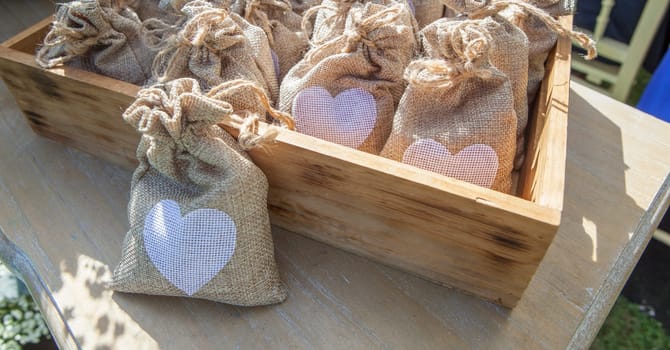 Sachets of rice ready to throw away after a wedding ceremony. Wooden box container
