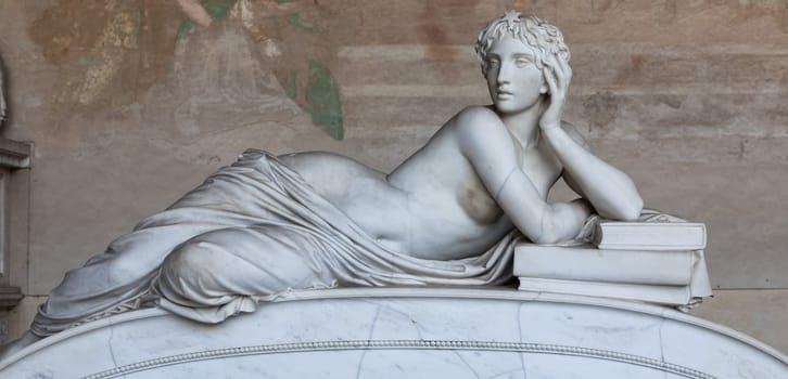 Pisa, Italy - 29 June 2023: sad statue in cemetery. Vintage white marble sculpture, woman sorrow