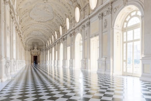 Reggia di Venaria Reale, Italy - October 2022: corridor perspective, luxury marble, gallery and windows - Royal palace