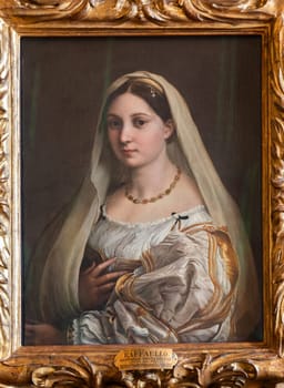 Florence, Italy - 23 September 2023: Pitti Palace antique painting museum. The vailed woman - La velata - by Raphael - Raffaello Sanzio, 1514.