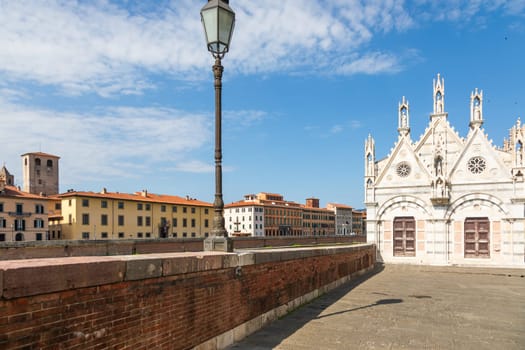 Pisa, Italy - 29 June 2023: colourful buildings on Arno river. Urban skyline, travel destination.