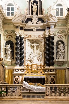 Ventimiglia, Italy - August 2022: the baroque church interior of Oratorio dei Neri with Jesus Christ statue