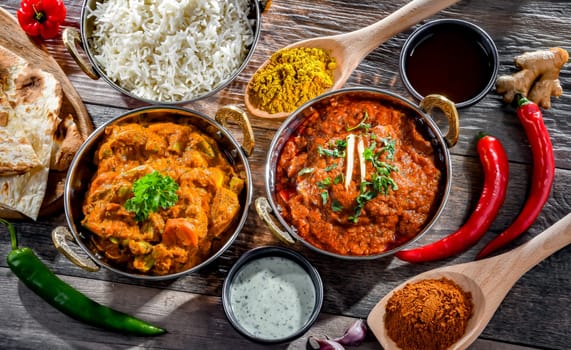 Hot madras paneer and vegetable masala with basmati rice served in original indian karahi pots.