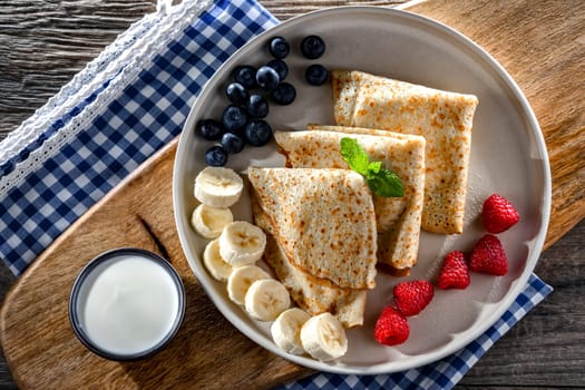 A plate of home-made Polish pancakes filled with sweet cottage cheese
