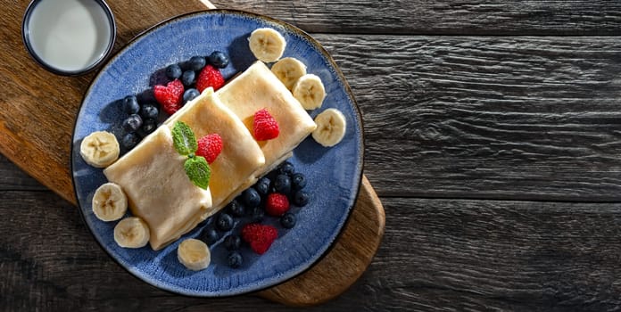 A plate of home-made Polish pancakes filled with sweet cottage cheese