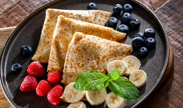 A plate of home-made Polish pancakes filled with sweet cottage cheese