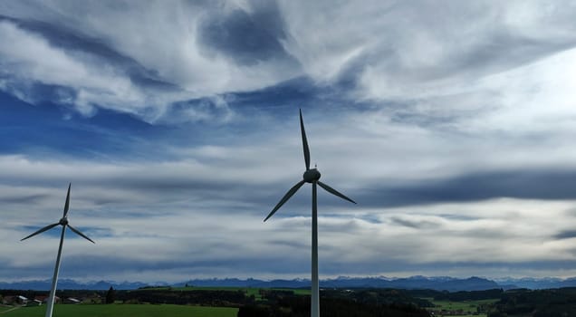Drone photo of wind turbines at sunset in front of the Allgäu Alps