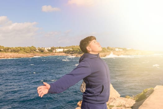 young hispanic with open arms praying to jesus, receiving spiritual blessing from our lord jesus christ