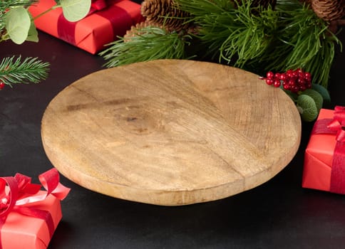 Empty round wooden platform for displaying products in the middle of Christmas decor