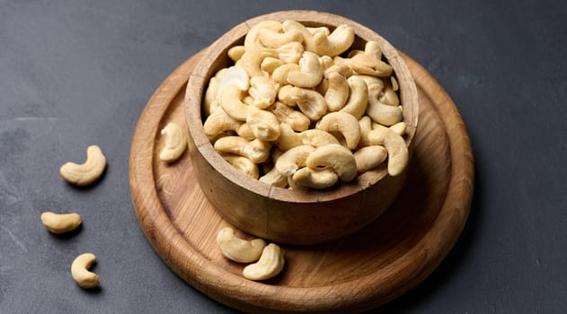 Cashews in a wooden bowl on the table
