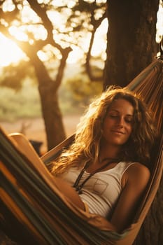 The girl swinging in the hammok on the seashore on the sunrise. beachtime.