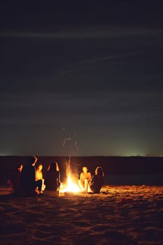 Inviting campfire on the beach during the summer, bring back fond memories. Fun and good times at the lake or sea.