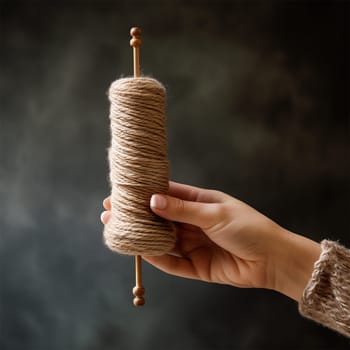 Woman's hand with spindle and yarn. ancient crafts