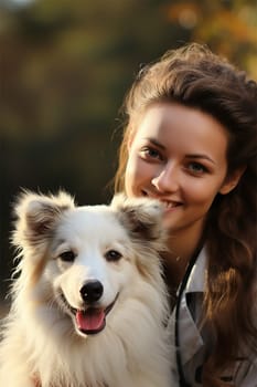 portrait of a young woman with her pet dog in the park.