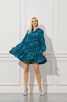 Cheerful woman waving her short loose dress