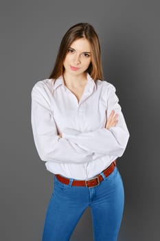 Top view of smiling woman with folded arms looking with inspiring enthusiasm