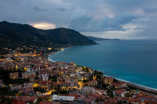Gioiosa Marea, Sicily, Italy – 25 Sep 2023. Panoramic view of the town and the bay of Gioiosa Marea in the evening twilight in province of Messina.