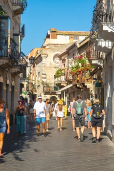 Taormina, Sicily, Italy - 28 September 2023. Tourists in the famous main street Corso umberto in Taormina. City views, facades, architecture and the most popular streets.