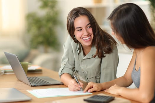 Happy tele workers signing contract working at home