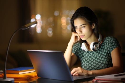 Student in the night e-learning using laptop at home