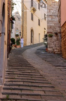 Massa Marittima, Italy - Sept 11, 2022: Steep and narrow street in old town of Massa Marittima, Italy