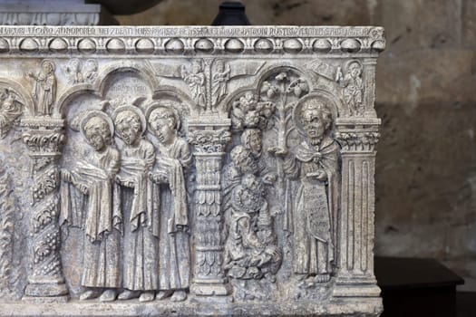 Massa Marittima, Italy - Sept 11, 2022:  Monumental baptismal font, with a rectangular bath surmounted by a small temple. The baptistery dates from 1267. Cathedral of Saint Cerbonius in Massa Marittima. Italy