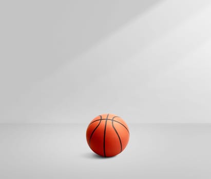 A basketball in a white room with light