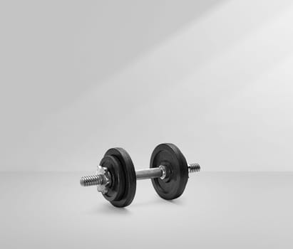 dumbbells in a white room with light
