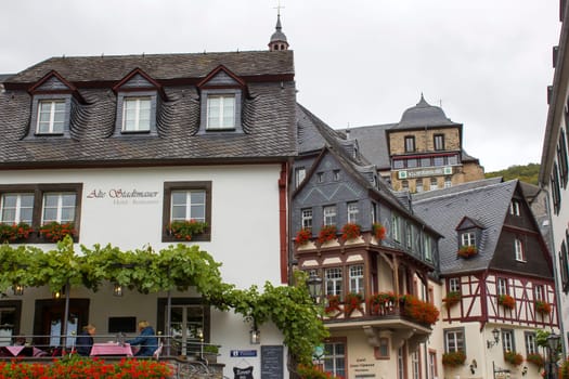 BEILSTEIN, GERMANY - OCTOBER 03 2019: historic village along the river Moselle with old half-timbered houses and the ruins of castle Metternich on top of the hills