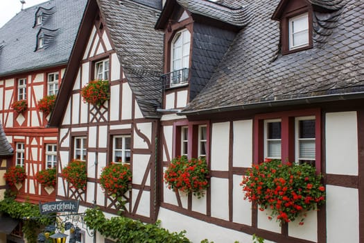BEILSTEIN, GERMANY - OCTOBER 03 2019: historic village along the river Moselle with old half-timbered houses and the ruins of castle Metternich on top of the hills