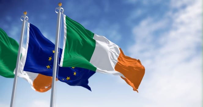 Flags of Ireland and the European Union waving on a clear day. Ireland became a member of the European Union on 1973. 3d illustration render. Rippling fabric. Selective focus