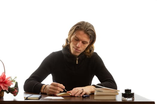 A student sits at a table and write a notebook on a white background