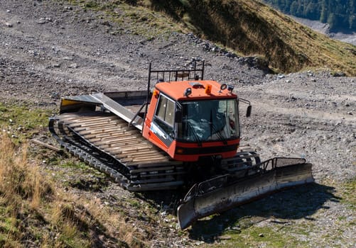 a snow groomer machine abandoned in summer at ski resort